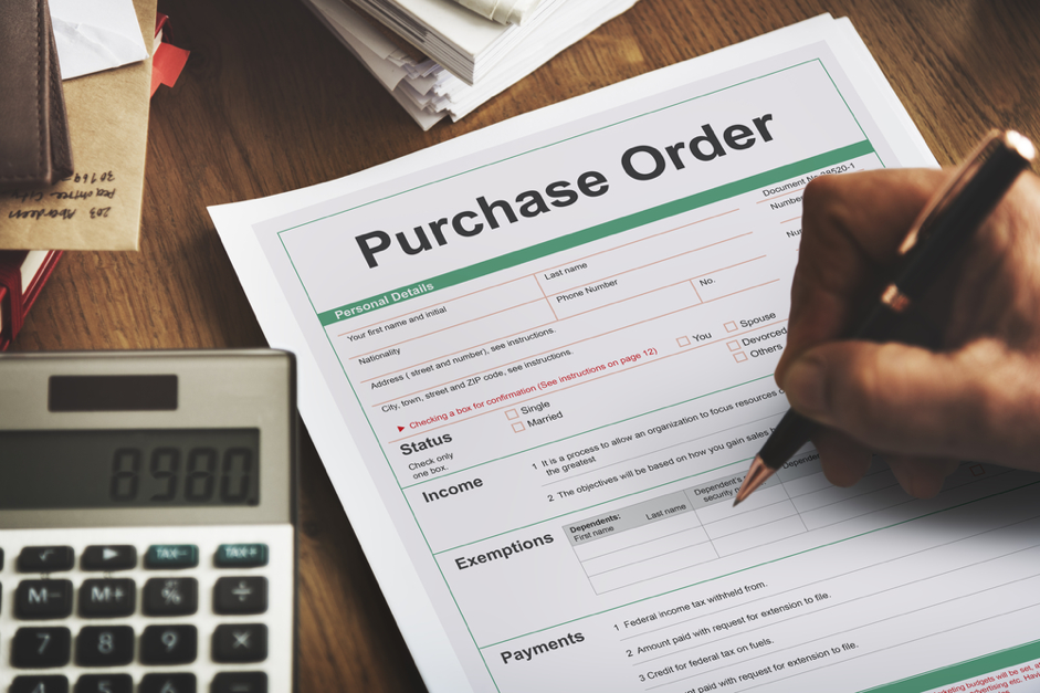 Business person filling out a purchase order. Convertibill® Finance